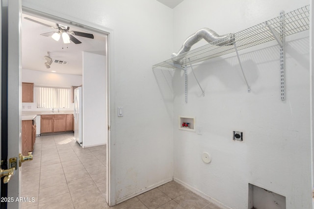 laundry area with hookup for a gas dryer, electric dryer hookup, washer hookup, ceiling fan, and light tile patterned floors