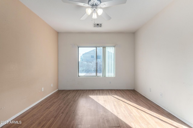 unfurnished room with ceiling fan and wood-type flooring