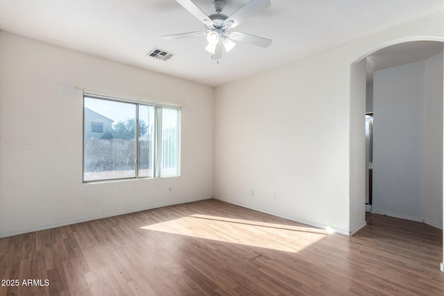 unfurnished room with ceiling fan and wood-type flooring