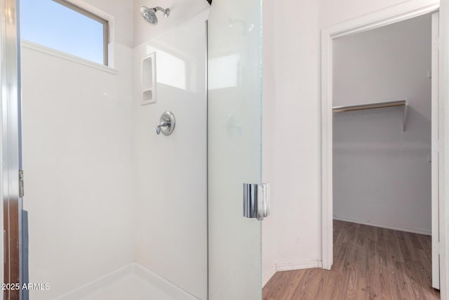 bathroom featuring hardwood / wood-style floors and a shower with door