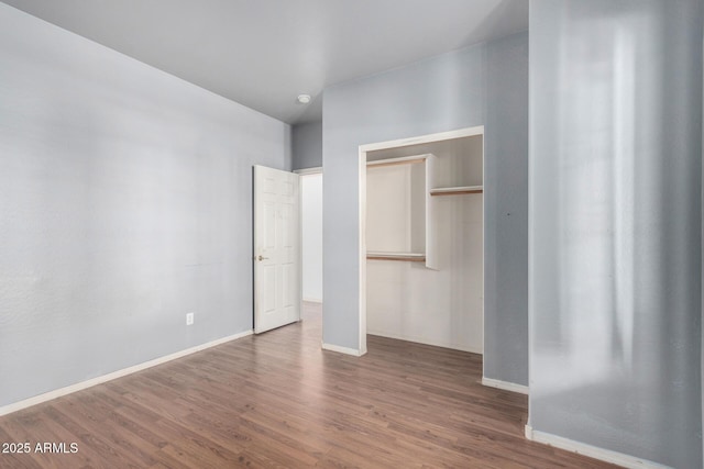 unfurnished bedroom with a closet and wood-type flooring