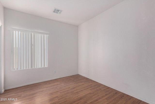 empty room with wood-type flooring