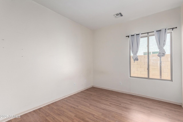 spare room with light hardwood / wood-style flooring