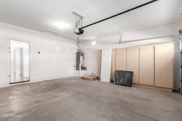 garage featuring water heater and a garage door opener