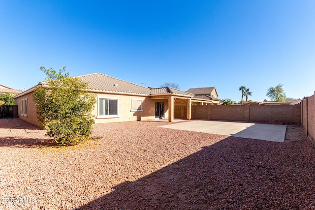 back of house with a patio