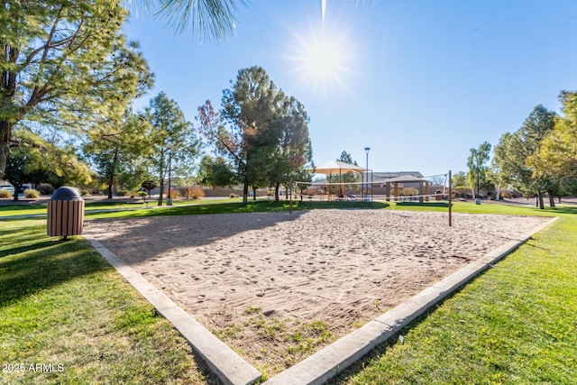 view of property's community featuring volleyball court and a yard