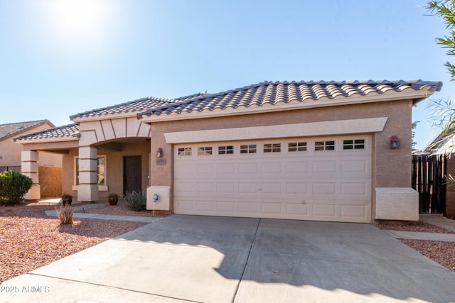 mediterranean / spanish home featuring a garage