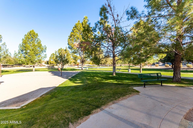 view of home's community featuring volleyball court and a yard