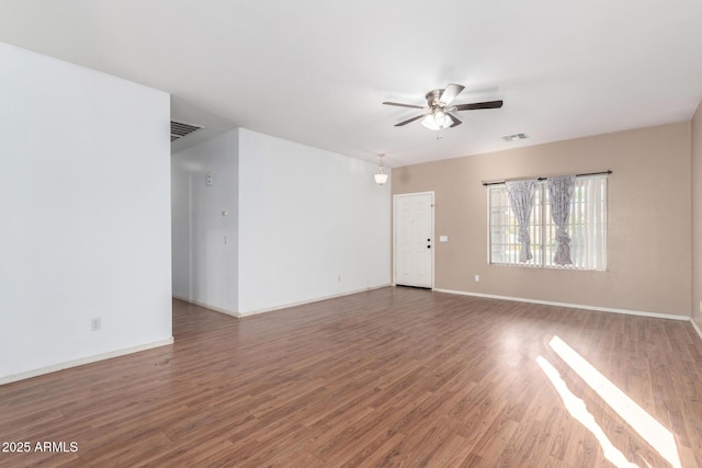 spare room with ceiling fan and dark hardwood / wood-style flooring