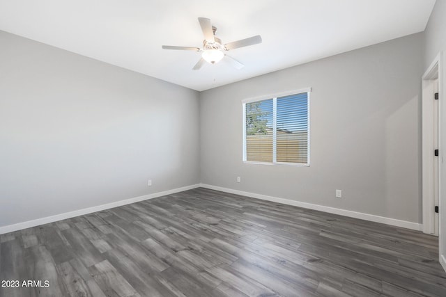 spare room featuring ceiling fan and dark hardwood / wood-style flooring