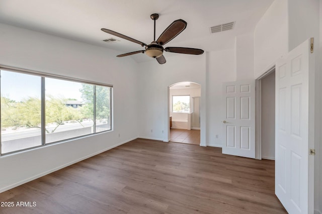 3900 S Velero St, Chandler, AZ 85249 - unfurnished bedroom with arched walkways, baseboards, visible vents, and wood finished floors