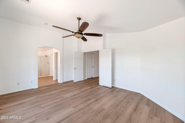 3900 S Velero St, Chandler, AZ 85249 - unfurnished bedroom featuring a ceiling fan, arched walkways, light wood-type flooring, baseboards, and ensuite bathroom