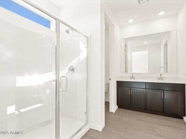5537 S 246th Ave, Buckeye, AZ 85326 - full bath with a stall shower, double vanity, and wood finished floors