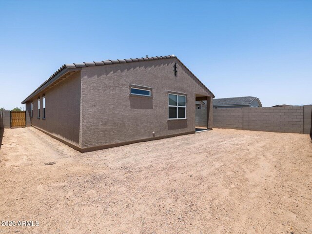 5537 S 246th Ave, Buckeye, AZ 85326 - rear view of property featuring a fenced backyard and stucco siding