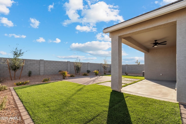 view of yard featuring a ceiling fan, a patio area, and a fenced backyard