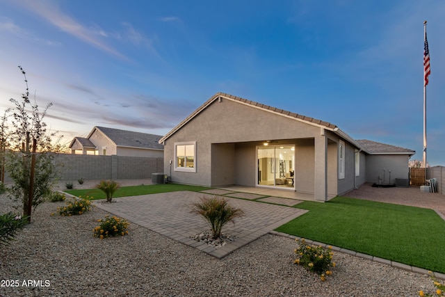 back of house featuring a ceiling fan, a fenced backyard, central air condition unit, a patio area, and stucco siding