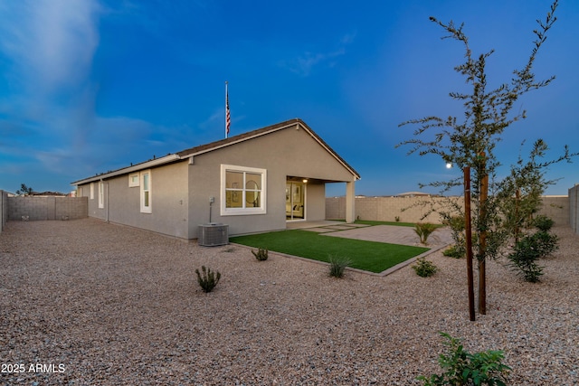 back of house with stucco siding, a fenced backyard, and a patio