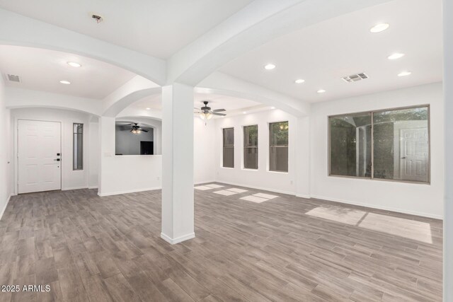 3444 E Flamingo Ct, Gilbert, AZ 85297 - unfurnished living room with a ceiling fan, wood finished floors, recessed lighting, and arched walkways