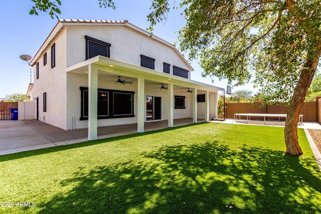 3444 E Flamingo Ct, Gilbert, AZ 85297 - rear view of house with ceiling fan, a fenced backyard, stucco siding, a patio, and a trampoline