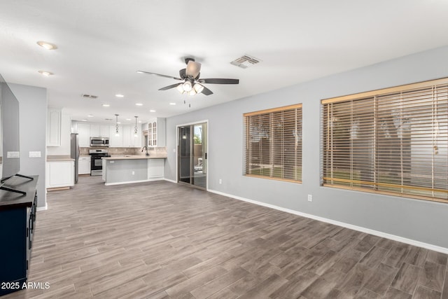 3444 E Flamingo Ct, Gilbert, AZ 85297 - unfurnished living room with light wood-type flooring, ceiling fan, and recessed lighting
