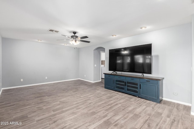 3444 E Flamingo Ct, Gilbert, AZ 85297 - unfurnished living room featuring arched walkways, light wood-type flooring, and ceiling fan