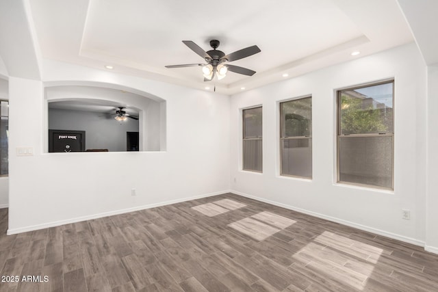 3444 E Flamingo Ct, Gilbert, AZ 85297 - spare room featuring ceiling fan, a raised ceiling, recessed lighting, wood finished floors, and arched walkways