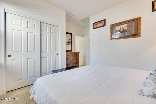 bedroom featuring light colored carpet and a closet