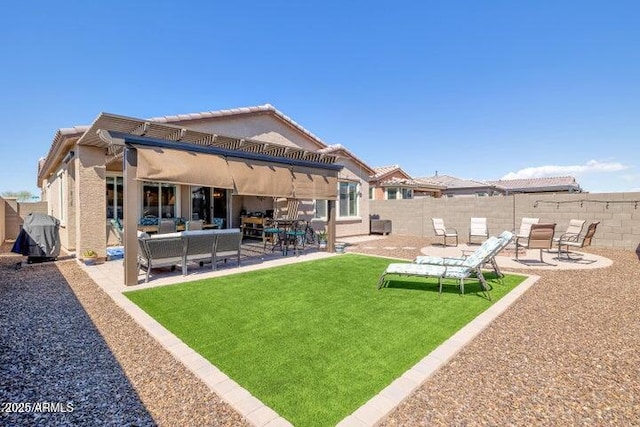 rear view of house with a lawn, an outdoor hangout area, and a patio