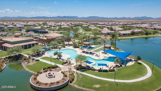 drone / aerial view with a water and mountain view