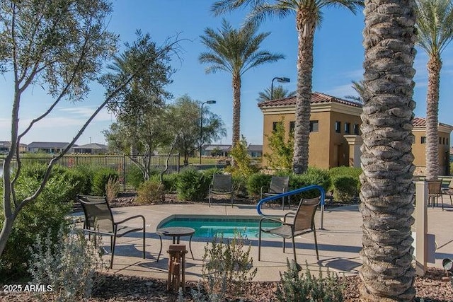 view of swimming pool with a patio area