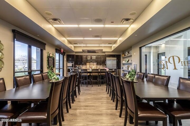 dining space featuring light hardwood / wood-style flooring and french doors