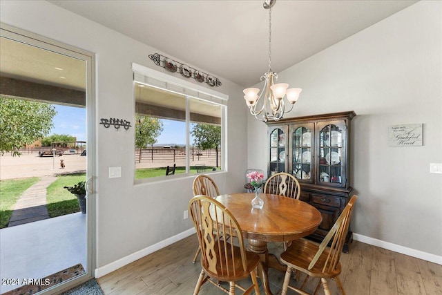 dining room with wood-type flooring and a chandelier