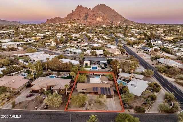 aerial view at dusk with a residential view and a mountain view