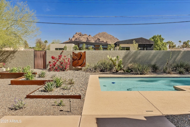 view of pool with a garden, a fenced backyard, and a fenced in pool