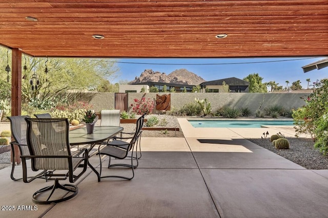 view of pool with outdoor dining space, a patio area, a fenced backyard, and a fenced in pool