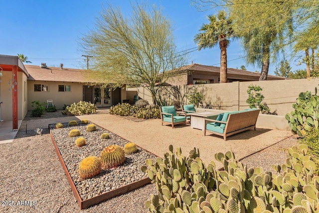 exterior space featuring french doors, a patio area, a fenced backyard, and an outdoor living space