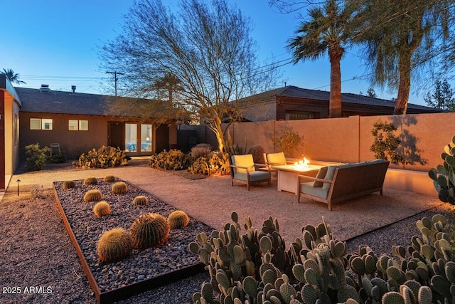 exterior space featuring an outdoor fire pit, french doors, and fence