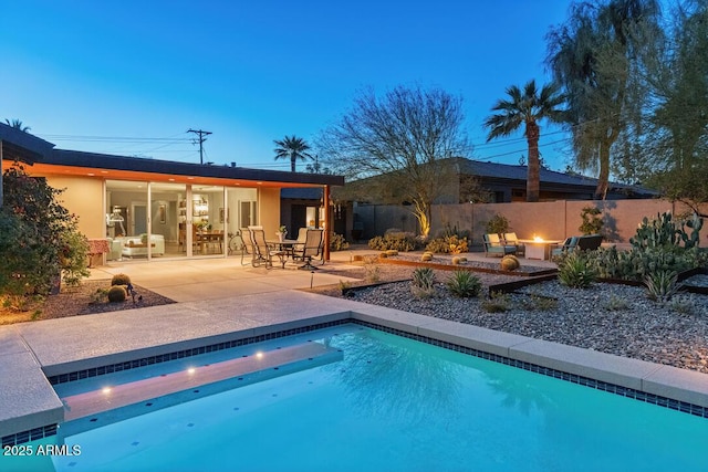 view of swimming pool featuring a fenced in pool, a patio, and fence