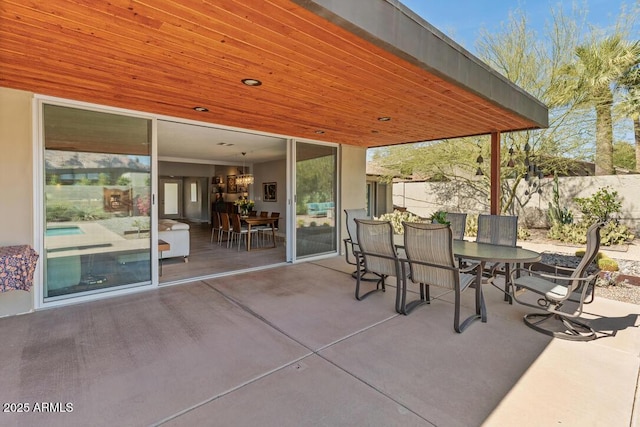 view of patio / terrace with outdoor dining space and fence