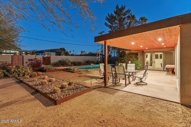 exterior space featuring a fenced backyard, a fenced in pool, and french doors