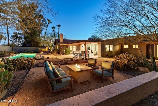 view of patio featuring an outdoor fire pit, fence, and a fenced in pool