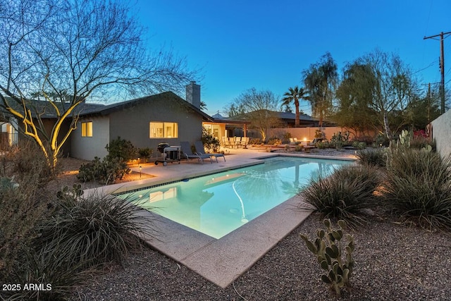 view of swimming pool with a patio, fence, and a fenced in pool