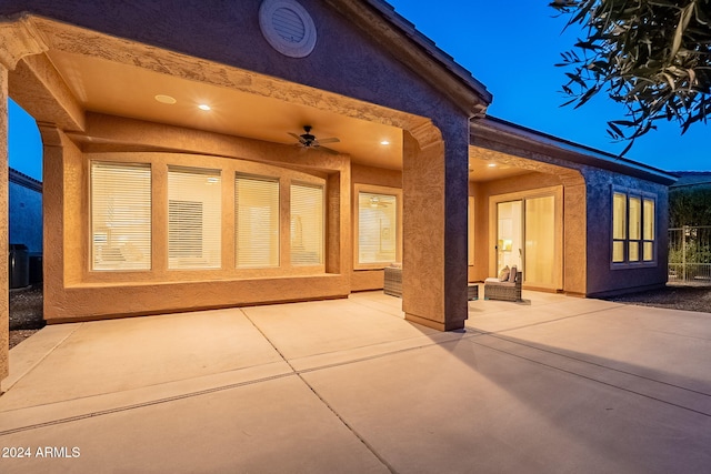 rear view of house featuring ceiling fan and a patio area