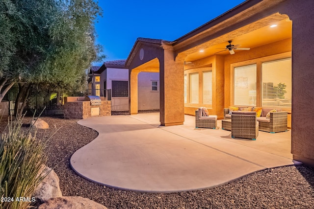 view of patio with an outdoor living space, area for grilling, and ceiling fan