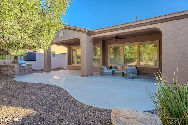 view of patio featuring ceiling fan, exterior kitchen, and an outdoor living space