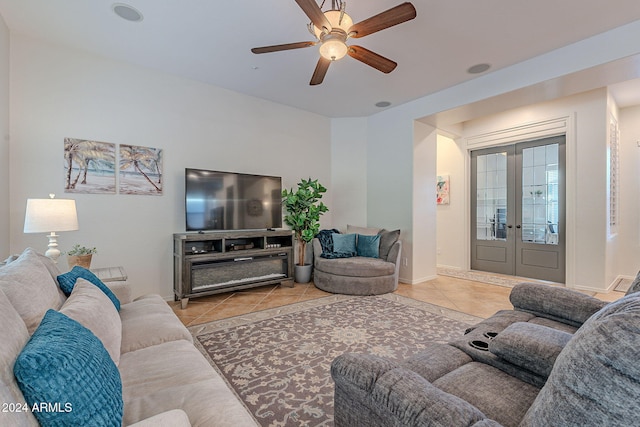 living room featuring light tile patterned flooring, ceiling fan, and french doors