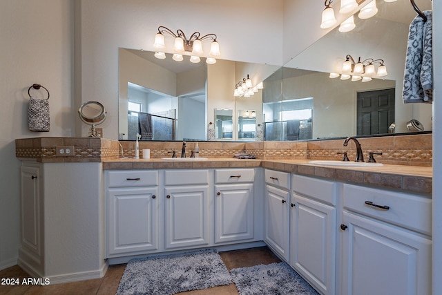 bathroom featuring decorative backsplash, an enclosed shower, vanity, and tile patterned flooring