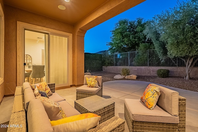 patio terrace at dusk with a mountain view and an outdoor hangout area