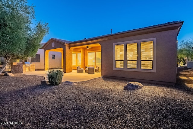 back of property featuring an outdoor kitchen, ceiling fan, and a patio area