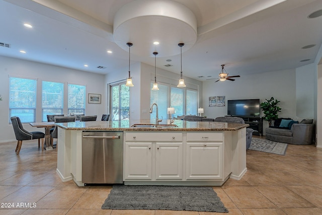 kitchen with pendant lighting, sink, ceiling fan, light stone countertops, and white cabinetry